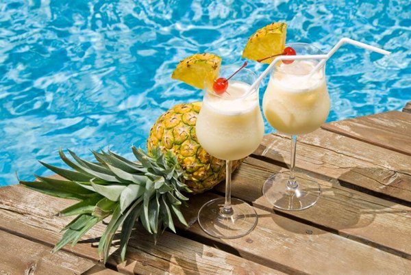 Two pina coladas by the pool